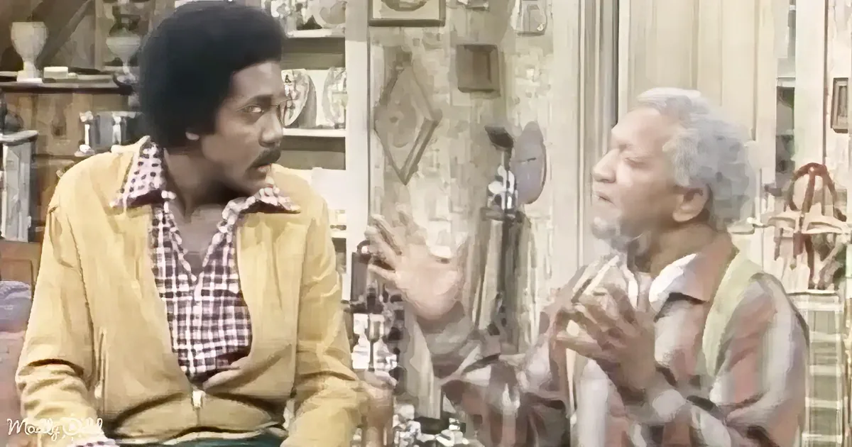 Two men are engaged in a conversation, one gesturing with his hands while the other listens attentively.