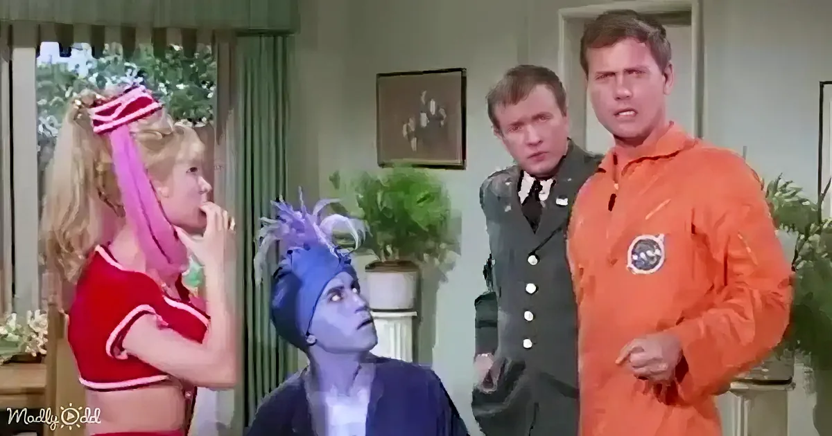 A woman in a red cheerleading outfit is surprised, while a blue alien and two men in uniforms look on.