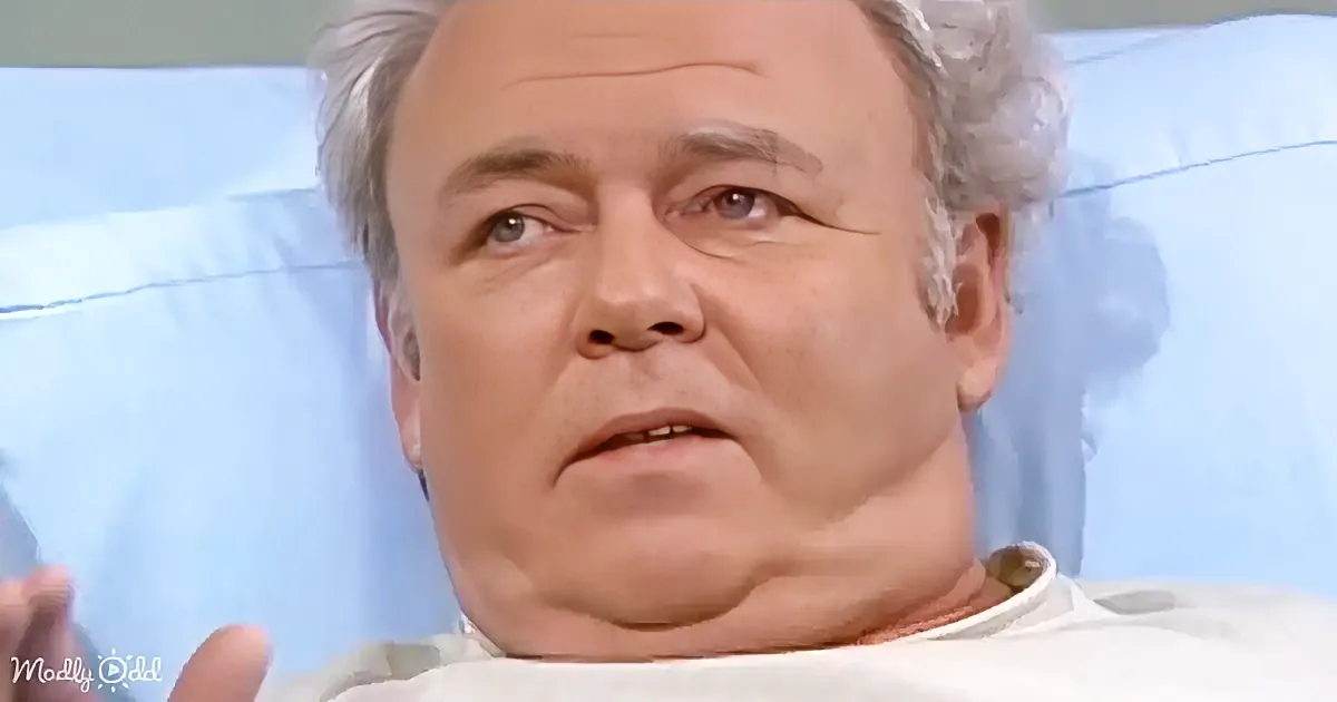A man with gray hair, wearing a white shirt, is lying down, appearing to be in a hospital or medical setting.