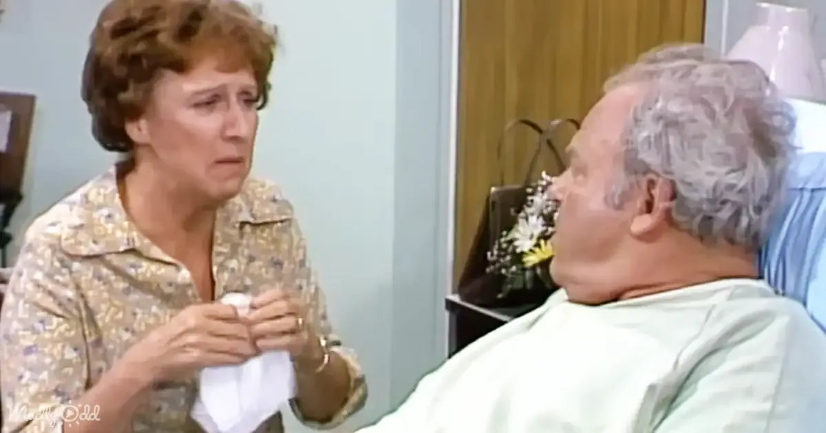 A woman in a floral shirt holds a tissue, looking concerned, while an elderly man lies in a hospital bed, appearing unwell.