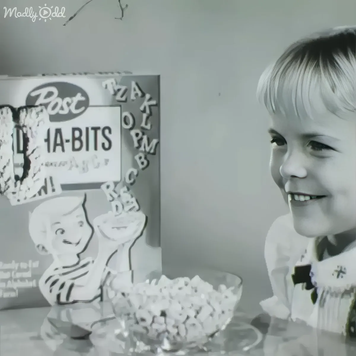 A smiling child sits beside a bowl of Post La-Bits cereal, with a cereal box in the background.