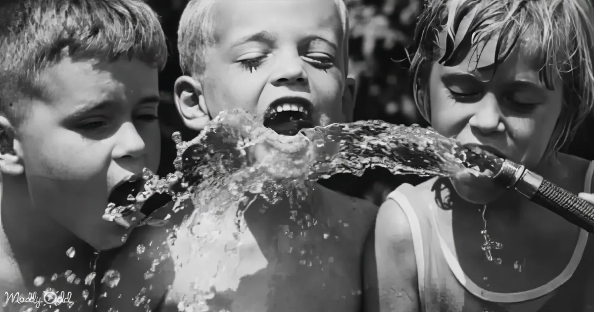 A child is being sprayed with water by two others, creating a playful splash.