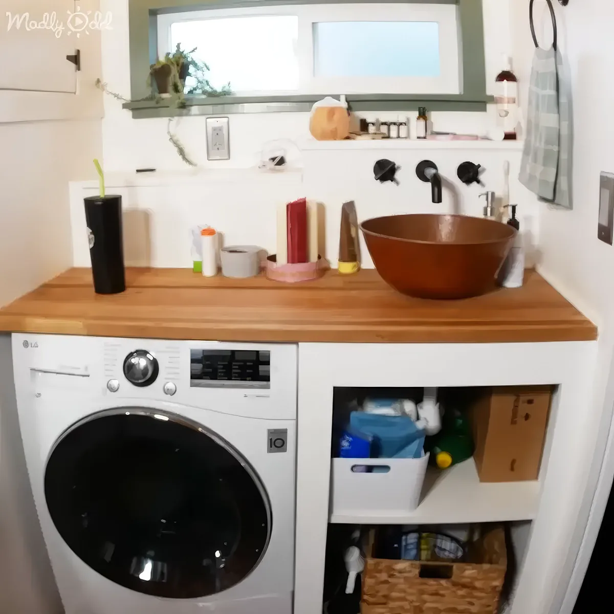 A compact laundry area with a wooden countertop, a washing machine, and shelves for storage.