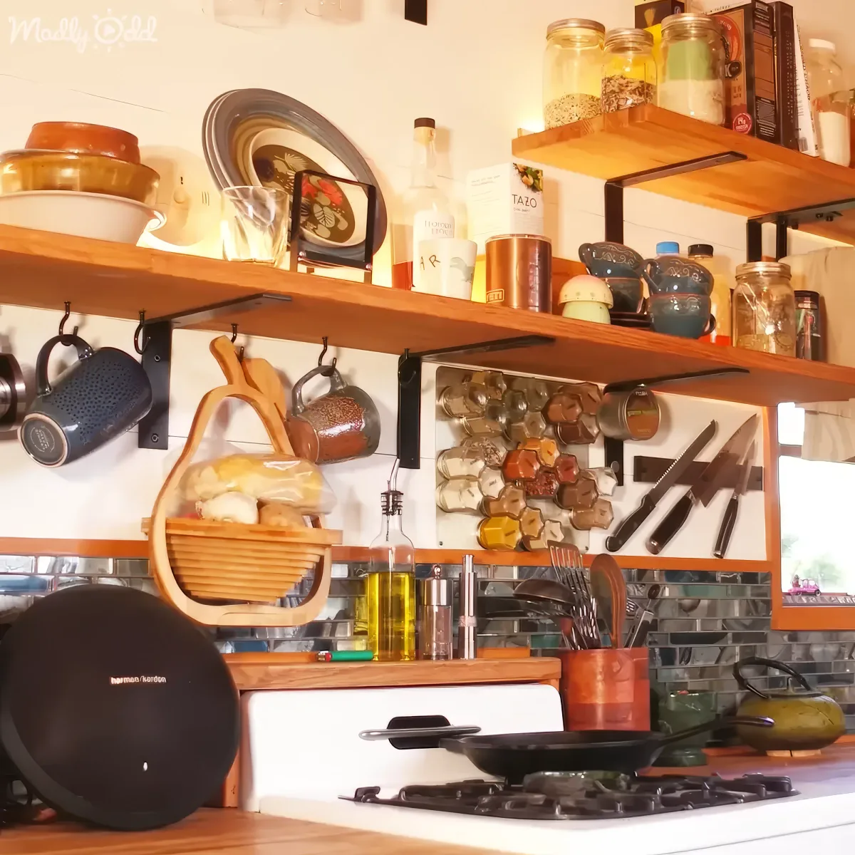 A cozy kitchen with wooden shelves holding various kitchenware, spices, and utensils, creating a warm and functional space.