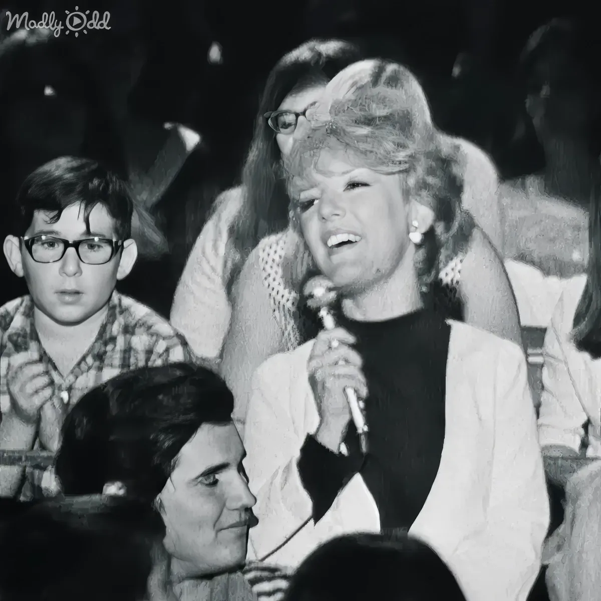 Petula Clark holds microphone singing with emotion