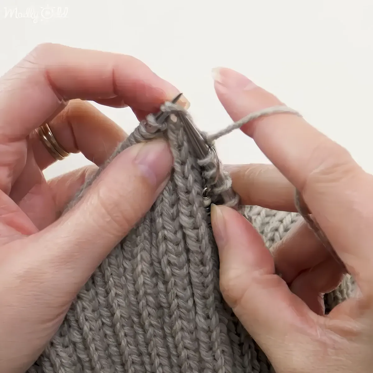 Close up of hands knitting colorful yarn