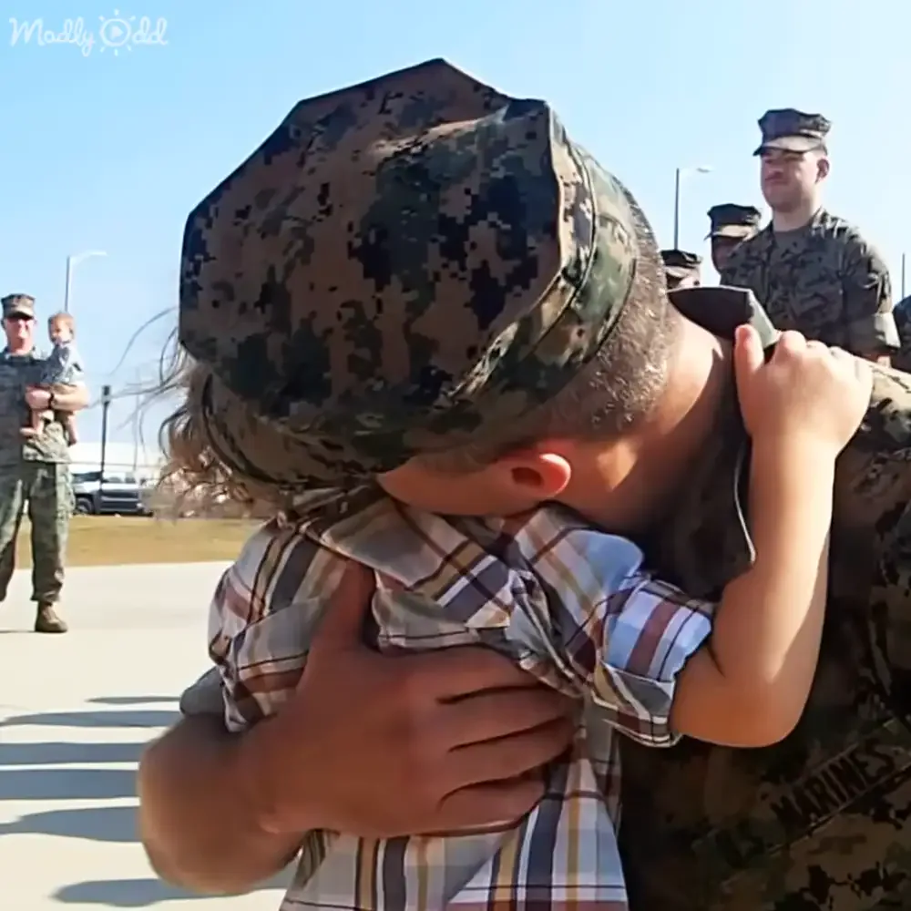 A touching moment between father and son in uniform.