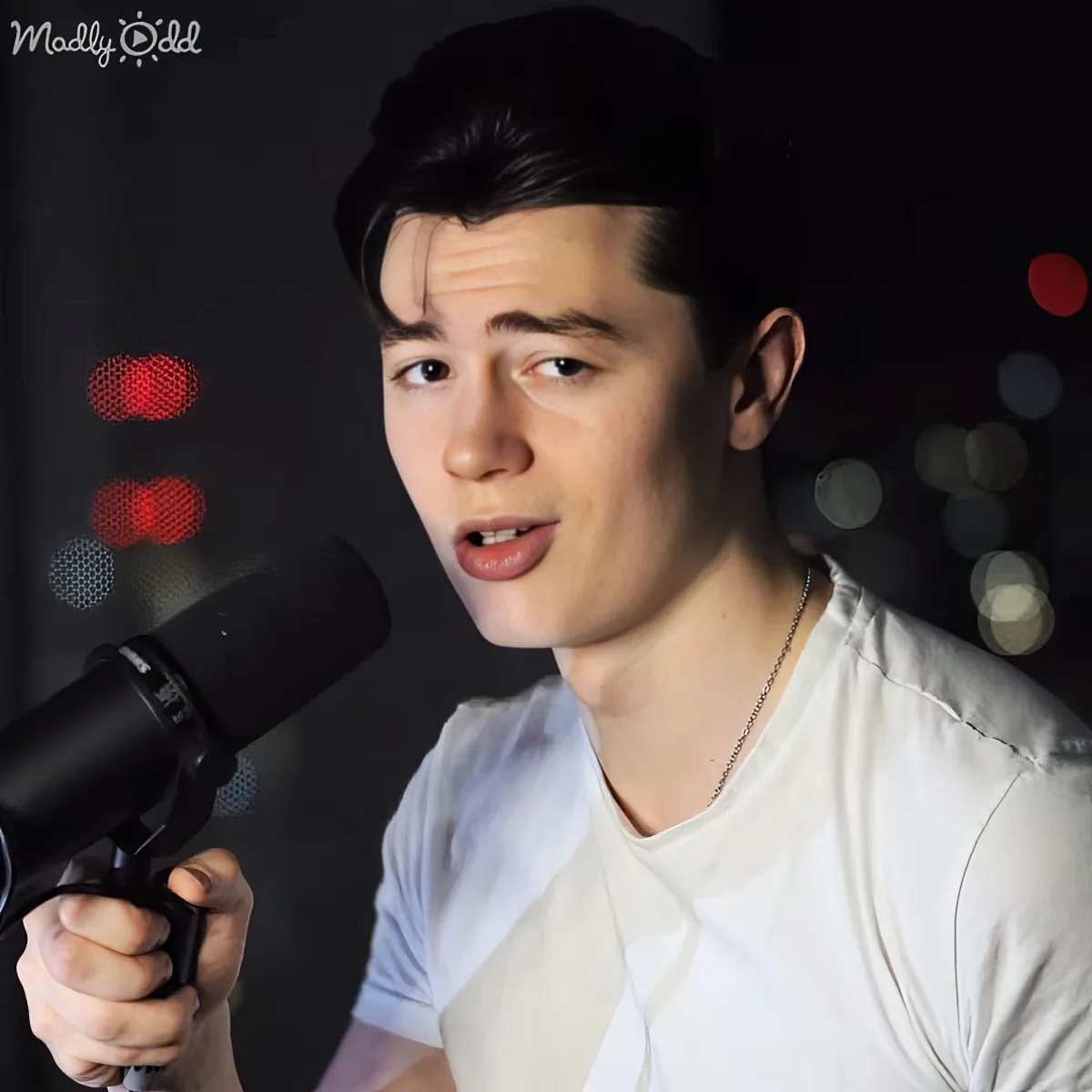Elliot Reay singing with a microphone