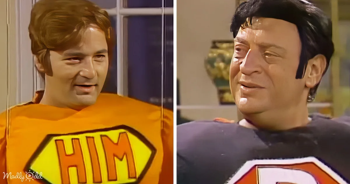 Two characters, one in an orange "HIM" shirt and another in a black uniform with a headband, both smiling.
