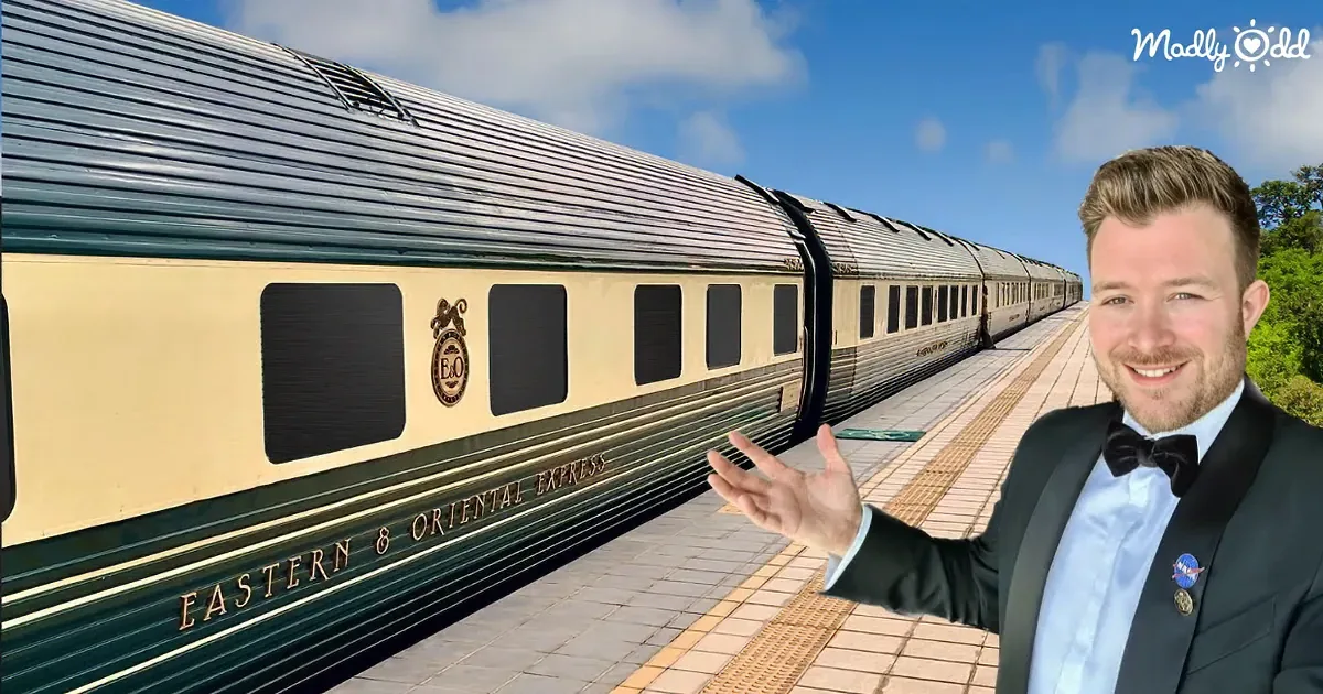 A man in a tuxedo stands on a platform next to a long train labeled "Eastern & Oriental Express."