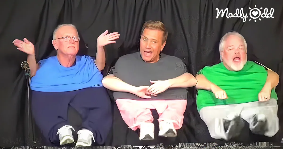 Three men in casual attire sit on a black background, appearing surprised or shocked.