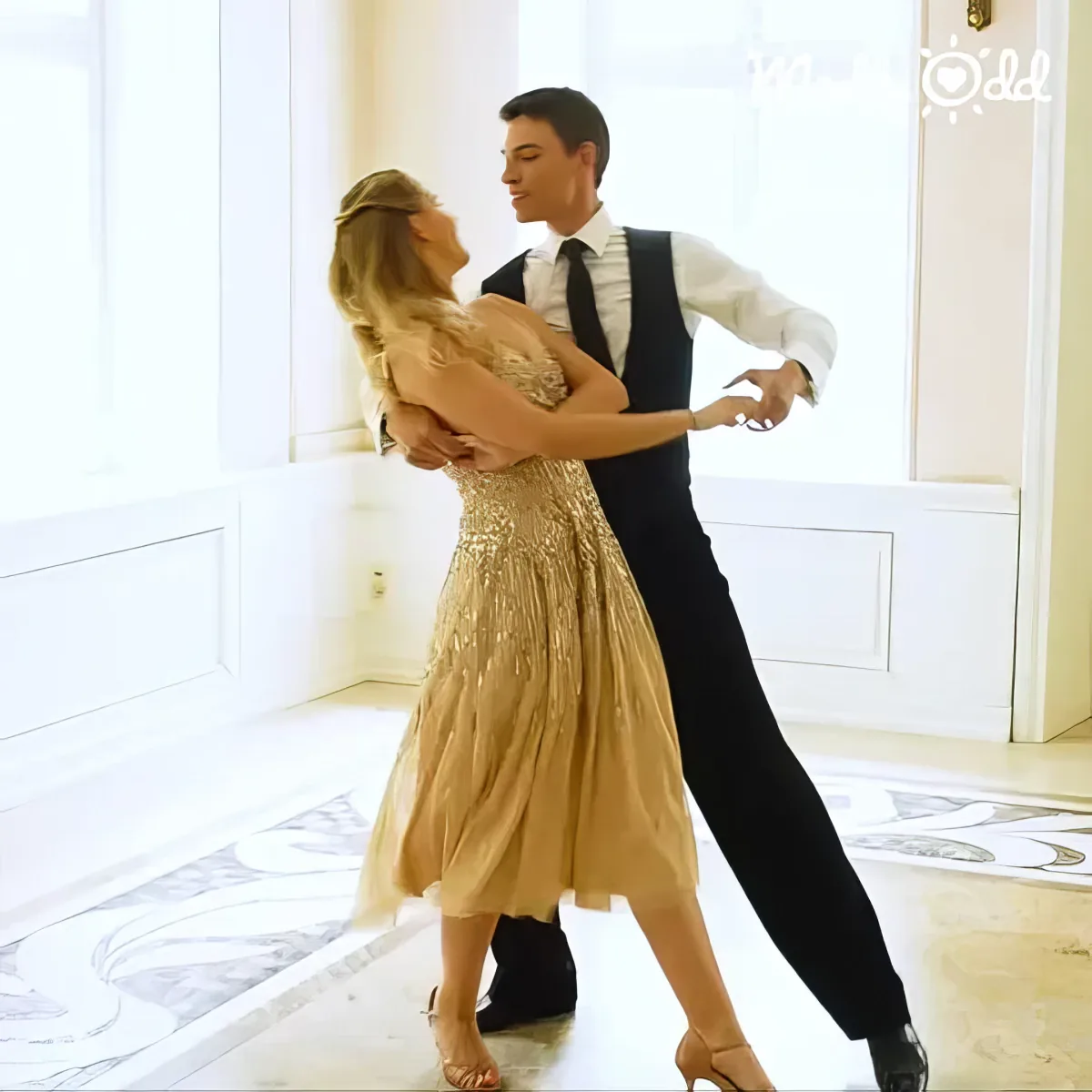 Couple dances to Nat King Cole's song, bride in white dress, groom in black suit.