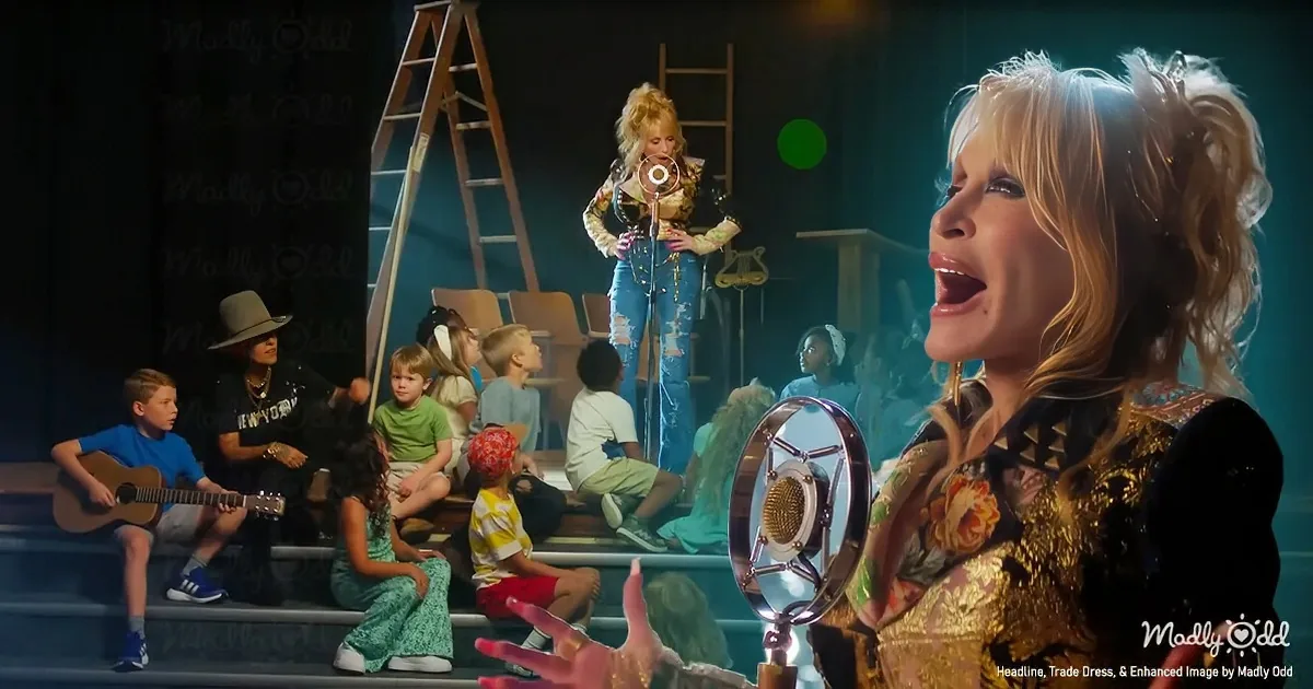 A woman in a gold outfit sings into a microphone, surrounded by children and another woman playing guitar.