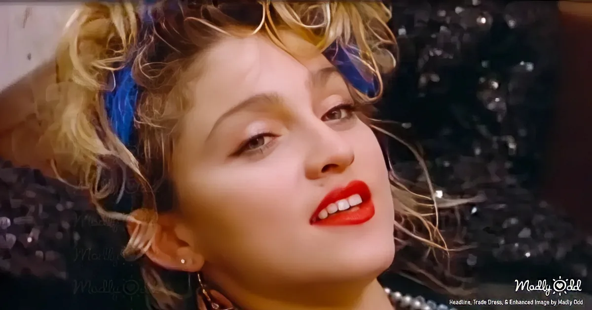 A person with curly blonde hair, red lipstick, and a blue headband is lying down, looking up.