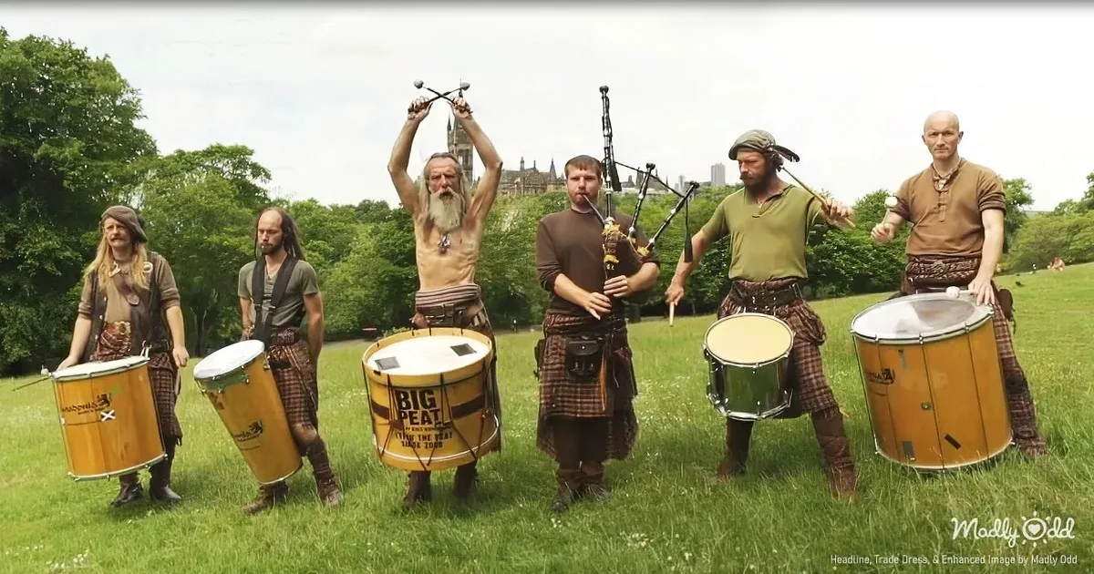 A group of musicians in traditional attire plays various instruments in a grassy field.