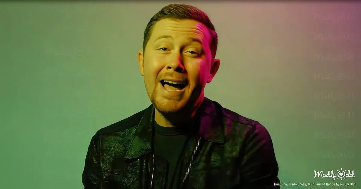 A man in a black leather jacket smiles brightly under colorful lighting.