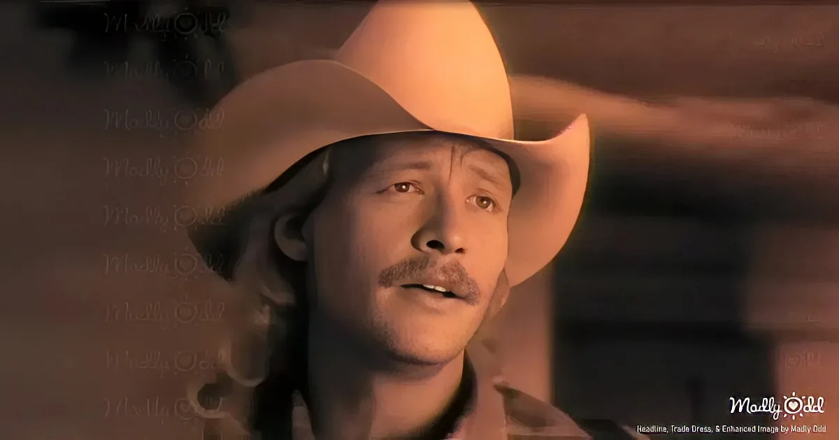 A man wearing a cowboy hat and a mustache, looking to the side with a serious expression.