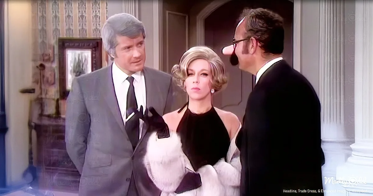 A woman in a white fur coat and black top stands between two men in suits, one with a large nose.