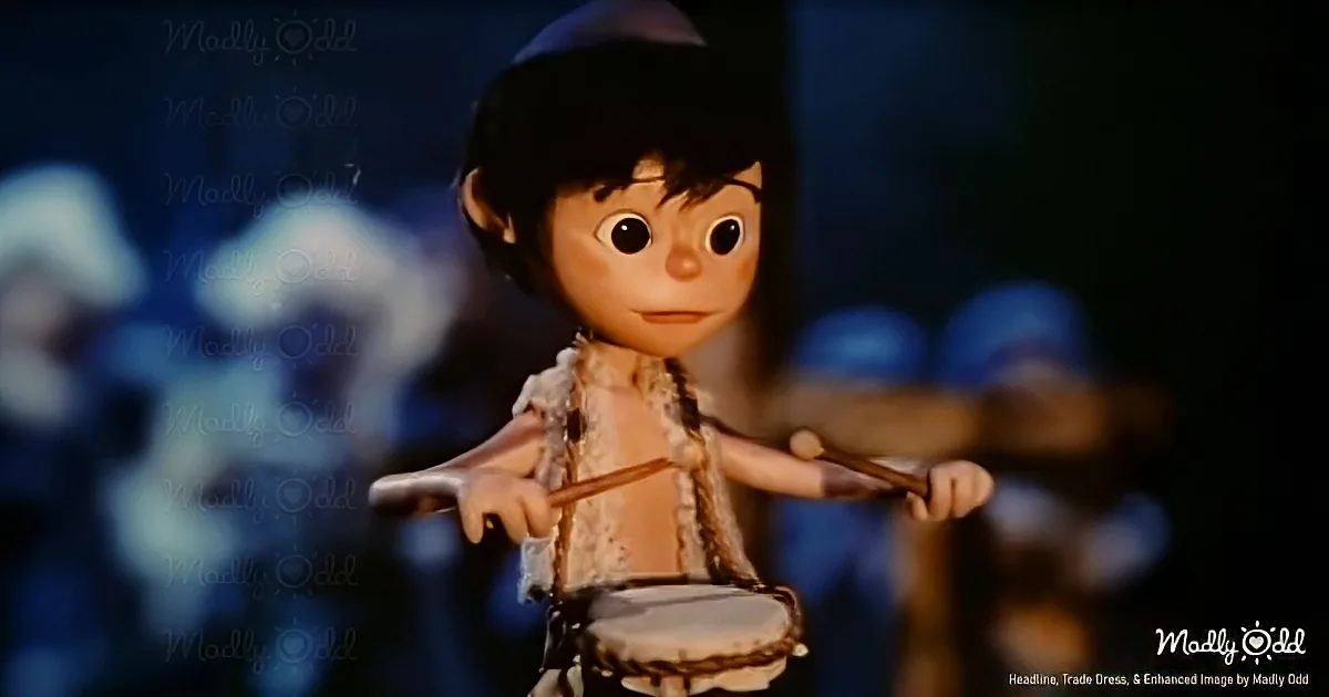 A cartoon character with drumsticks and a drum, wearing a white outfit, stands in front of a blurred background.