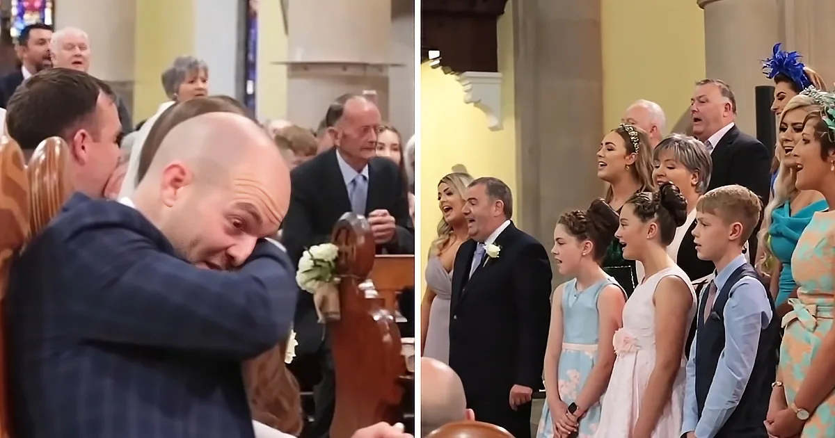 A man in a suit is visibly moved, covering his face, while a group of people, including children, sing in a church setting.