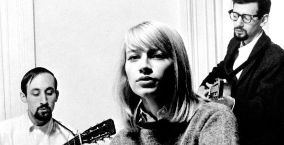 A collage of a woman singing with a man playing guitar, both in black and white.