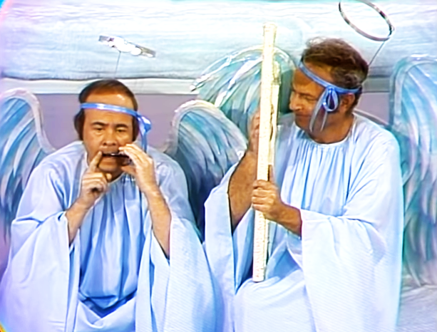 Two individuals in blue robes with halos, one holding a staff, both appearing angelic.