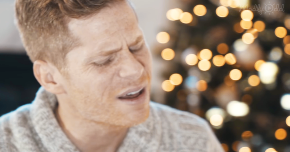 A person in a sweater appears to be crying, with blurred lights in the background.