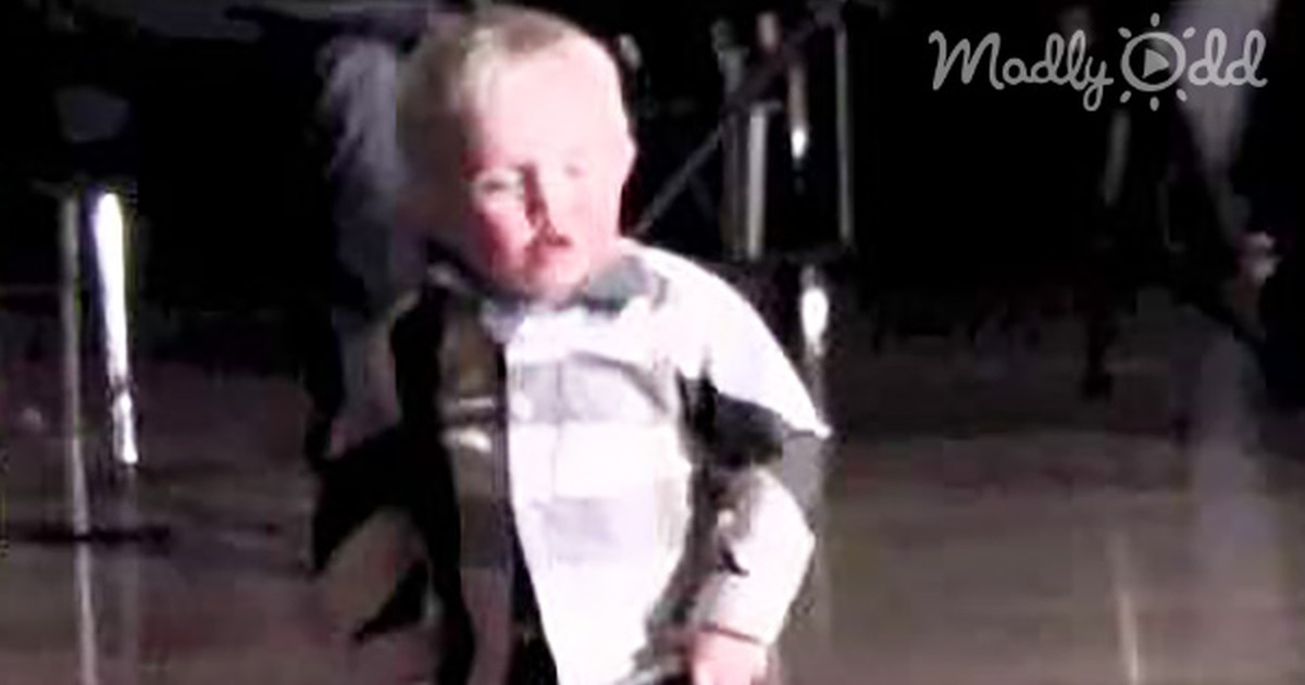 A young boy dances energetically on a stage, showcasing his moves to "I'm House Rock."