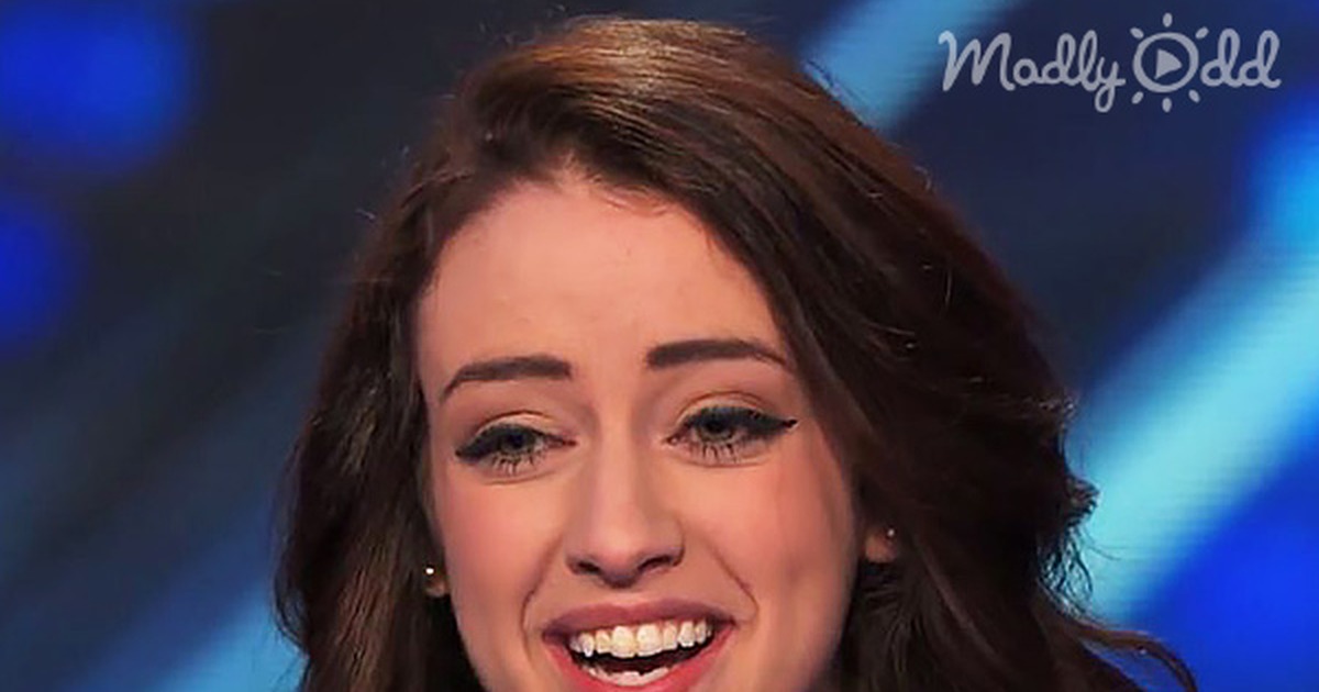 A smiling woman with long brown hair on America's Got Talent stage, text below about her anxiety disorder performance.