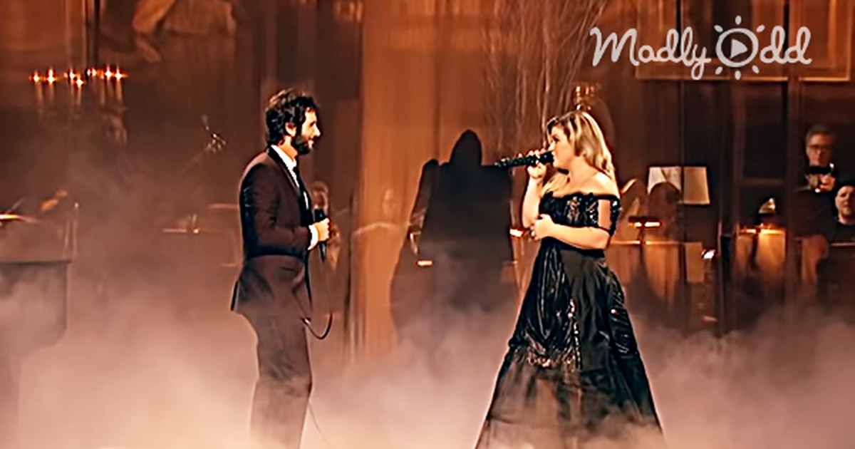 Josh Groban and Kelly Clarkson perform "All I Ask of You" on stage with smoke and audience.