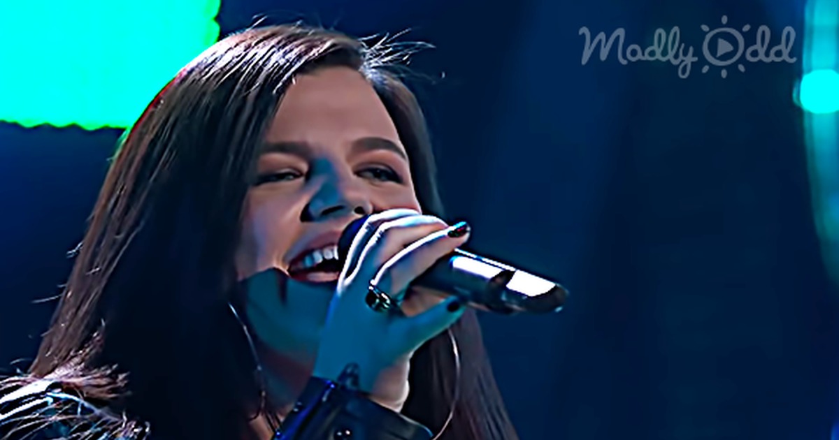 A 'Voice' contestant sings passionately, captivating John Legend with her a cappella opening.