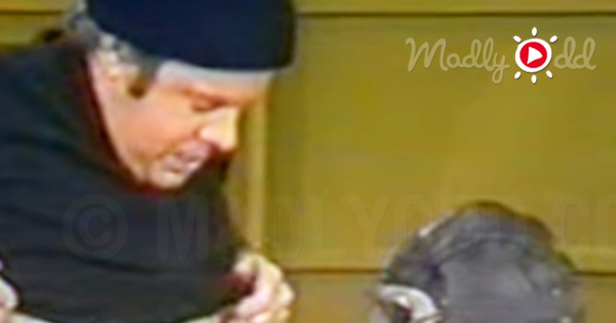 Tim Conway in a "O...ando" sketch, wearing a hat and shirt with writing, interacting with another person in a radio...